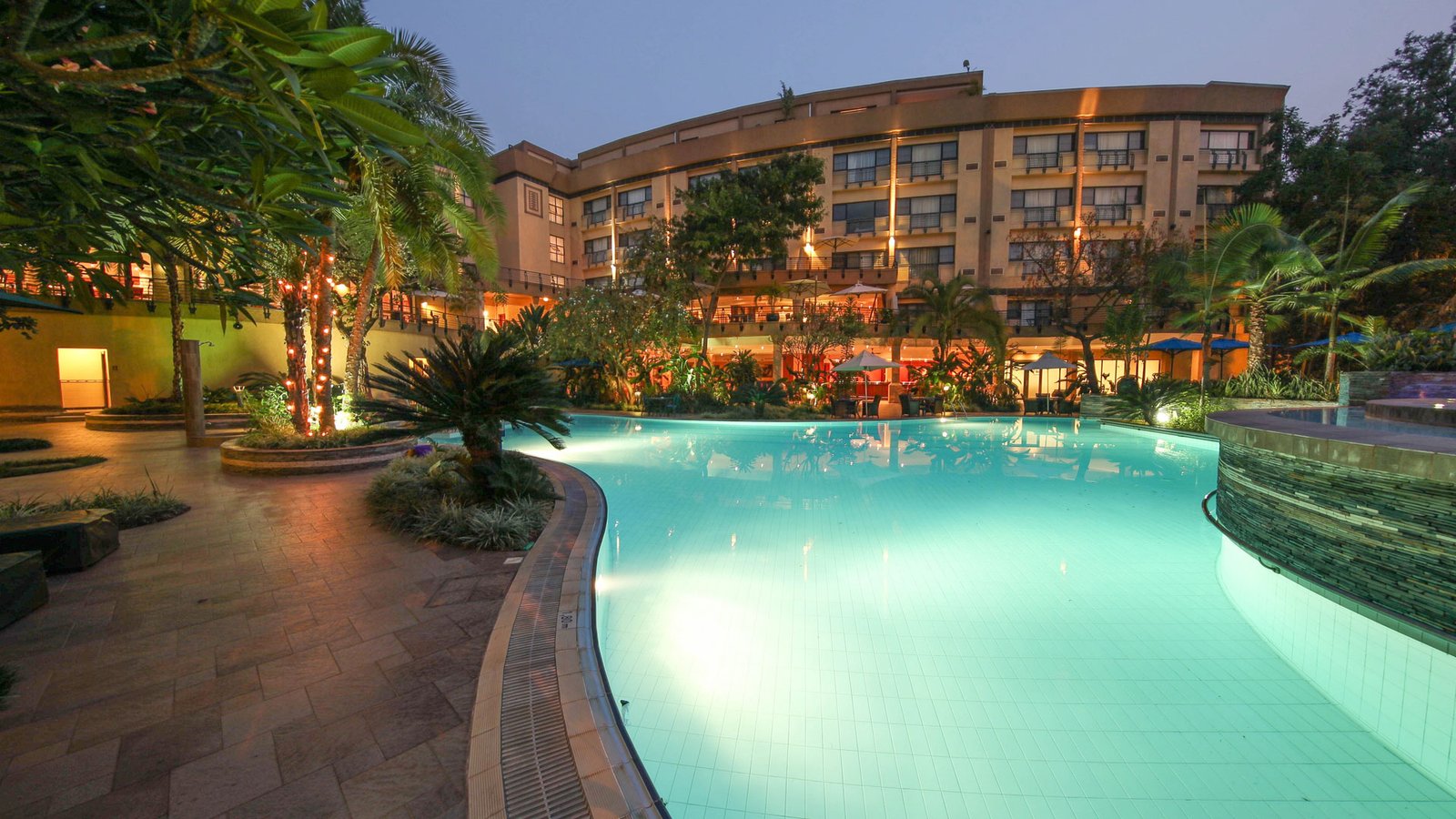 Kigali Serena Hotel poolside gardens at dusk